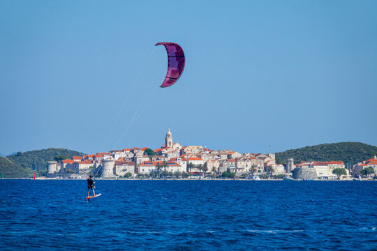 COPY SPACE: Athletic tourist kitesurfs near beautiful Korcula on a sunny day.