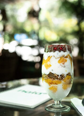healthy breakfast of yogurt, mango, muesli dry fruits and nuts 