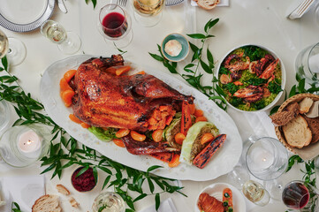 Beautiful festive table with variety of food and baked duck. Thanksgiving Day. Christmas. Top view. High quality photo - obrazy, fototapety, plakaty