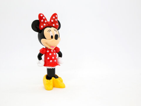 Minnie Mouse in her classic red polka dot dress. Toy. Cartoon character from Walt Disney Pictures Studios. Minnie is Mickey Mouse's girlfriend. Plastic doll. Daisy duck's friend. Isolated white.