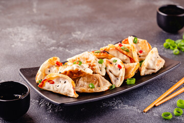 Fried dumplings served with green onions.