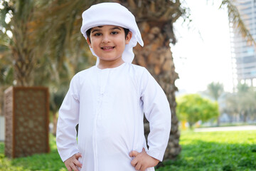 Young Arabic boy wearing traditional dish dash Kandoora. Portrait of Emirati student