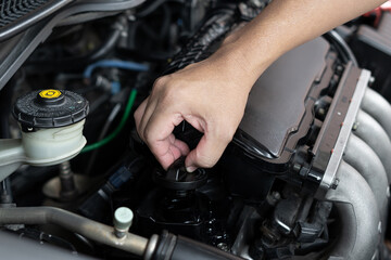 Fototapeta na wymiar Car technician man use screwdriver remove bolt in engine room service and maintenance concept