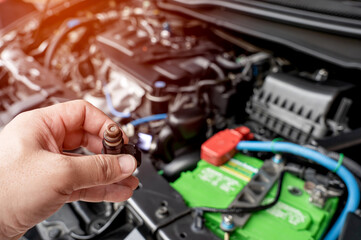 Technician check hole on old the gasoline injector part in engine room check dust and test pressure...