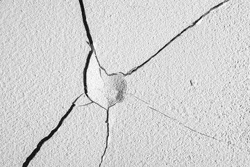 Cracks in the concrete wall.