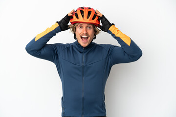 Young blonde cyclist man isolated on white background with surprise expression
