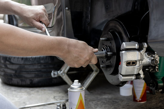 A man repairing and Simple test bolt of car wheel after repair paint and  maintenance that can be made by yourself