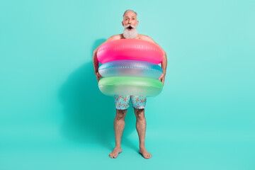 Full length body size view of nice funky cheerful bearded man wearing rubber rings diving isolated...