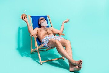 Photo of pretty cute retired man naked torso lying beach chair drinking cocktail empty space...