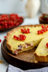 
homemade tart with red currants and gooseberries. on a white background, the atmosphere of morning and comfort