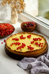 homemade tart with red currants and gooseberries. on a white background, the atmosphere of morning and comfort