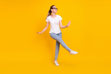 Fototapeta na wymiar Full length profile side photo of young woman happy positive smile have fun dance isolated over yellow color background