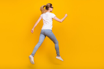 Fototapeta na wymiar Back rear spine view photo of young woman jump up run empty space dream sale isolated on yellow color background