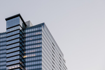 Modern abstract office building high rise skyscraper design in the city with glass windows 
