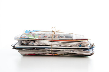 Stacked pressed and packaged household paper trash ready to be picked up for recycling. Close up studio shot, isolated on white, no people