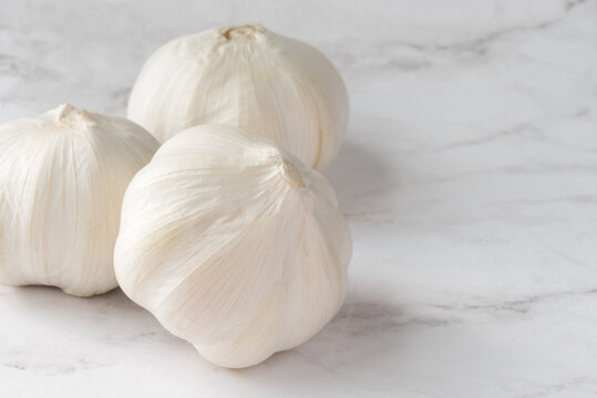 Three White Garlic Bulbs
