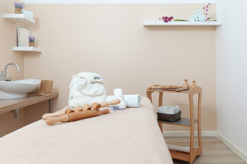 Beauty and body care center. A massage room with a bed, towels and other accessories.