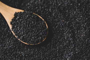 Black sesame on wooden spoon 