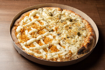 Pizza, pizza delivery inside the cardboard box used for delivery on a table, selective focus
