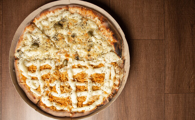 Pizza, pizza delivery inside the cardboard box used for delivery on a table, top view.