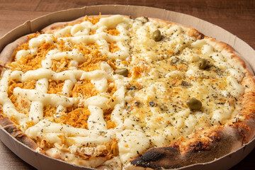 Pizza, pizza delivery inside the cardboard box used for delivery on a table, selective focus