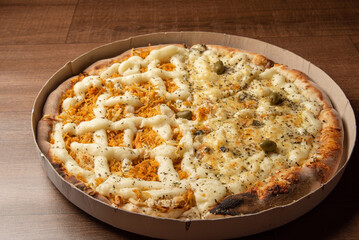 Pizza, pizza delivery inside the cardboard box used for delivery on a table, selective focus