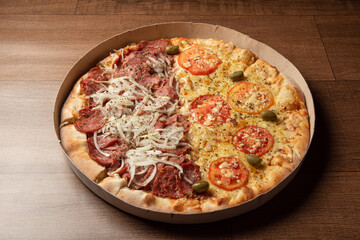 Pizza, pizza delivery inside the cardboard box used for delivery on a table, selective focus