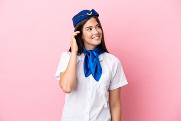 Airplane stewardess Brazilian woman isolated on pink background thinking an idea