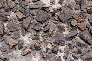 Fototapeta premium Stones embedded in the wall. Abstract background of stones