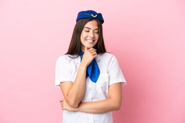 Airplane stewardess Brazilian woman isolated on pink background looking to the side