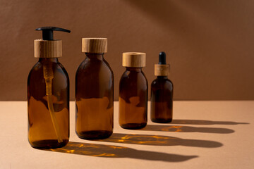 Eco friendly bottles for cosmetics. Glass bottle with a wooden lid with a dispenser and a pipette. Beauty and skin care. Brand packaging, place for text. Bottle products. Minimalism concept.