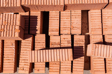Stacked red bricks with ribbed sides, top-down view.