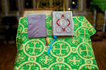 Church attributes in the form of a bible decorated with a silver cover and a pulpit with a green...