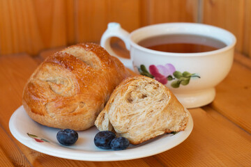 Bread texture close up. Fresh bread bun with tea close-up.
Whole grain bread on a plate close-up. Fresh bread Healthy food and traditional bakery concept