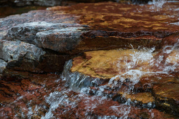 Water flowing over brown rocks