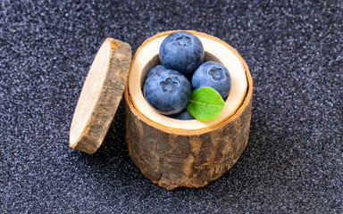 Stump shaped wooden bowl with blueberries