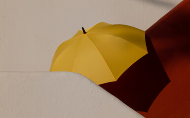 Yellow umbrella on white and red stairway