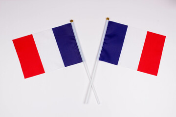 Flag of France and flag of France crossed with each other on a white background. Isolated. The image illustrates the relationship between countries. Photo for news and articles on the media