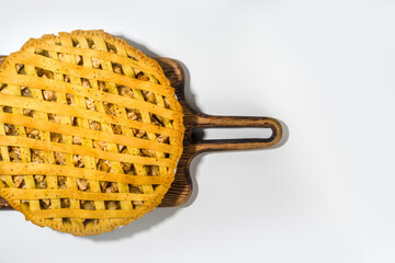 Autumn cooking baking background with sweet apple pie. Traditional american apple pie with fresh apples, cinnamon, spices, baking ingredients, top view copy space on white background