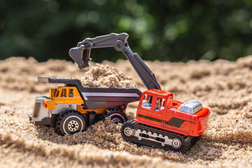 Re-enacting a building lot with toys in a sandbox