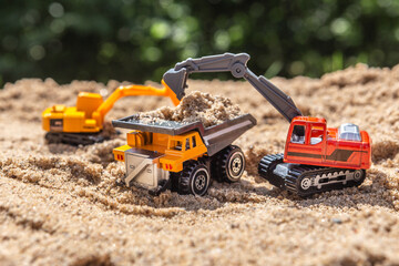 Re-enacting a building lot with toys in a sandbox