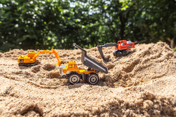 Re-enacting a building lot with toys in a sandbox