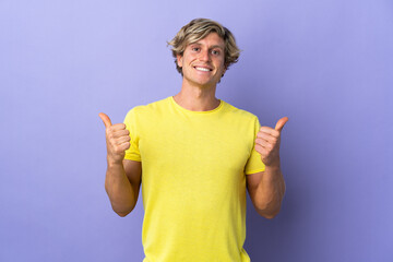 English man over isolated purple background with thumbs up gesture and smiling