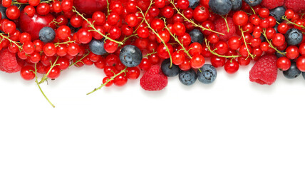 Different berries isolated top view, cherries with blueberries, red currants and raspberries with copy space at the white background