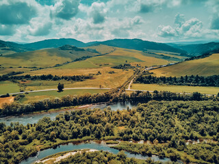 Beautiful aerial panoramic view of the Pieniny National Park, Poland in sunny day. Sokolica and Trzy Korony - English: Three Crowns (the summit of the Three Crowns Massif) and Dunajec river © udmurd