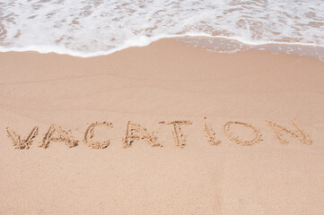Vacation Inscription  on a sandy sea coast