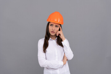 pondering female construction worker. businesswoman in builder hardhat.