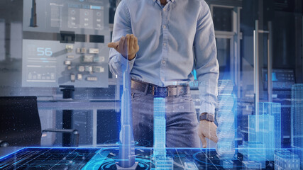 Professional Architect works with Holographic Augmented Reality 3D City Model using gestures. Technologically Advanced Office use Augmented Virtual Modeling Software Application on Futuristic Display.