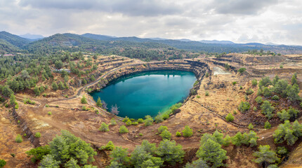 Panorama of old copper mining area with lake and mine tailings near Kapedes, Cyprus