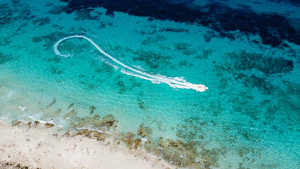 Aerial view of the beaches of Ses Illetes on the island of Formentera in the Balearic Islands, Spain - Turquoise waters on both sides of a sand strip in the Mediterranean Sea